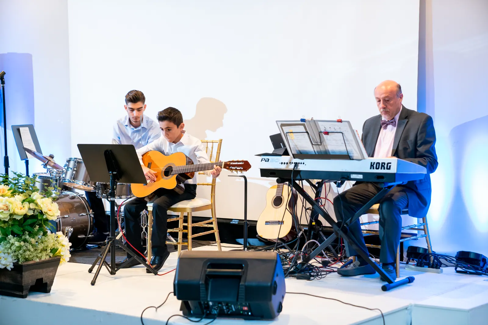 Young musicians performing guitar, keyboard, and drums together
