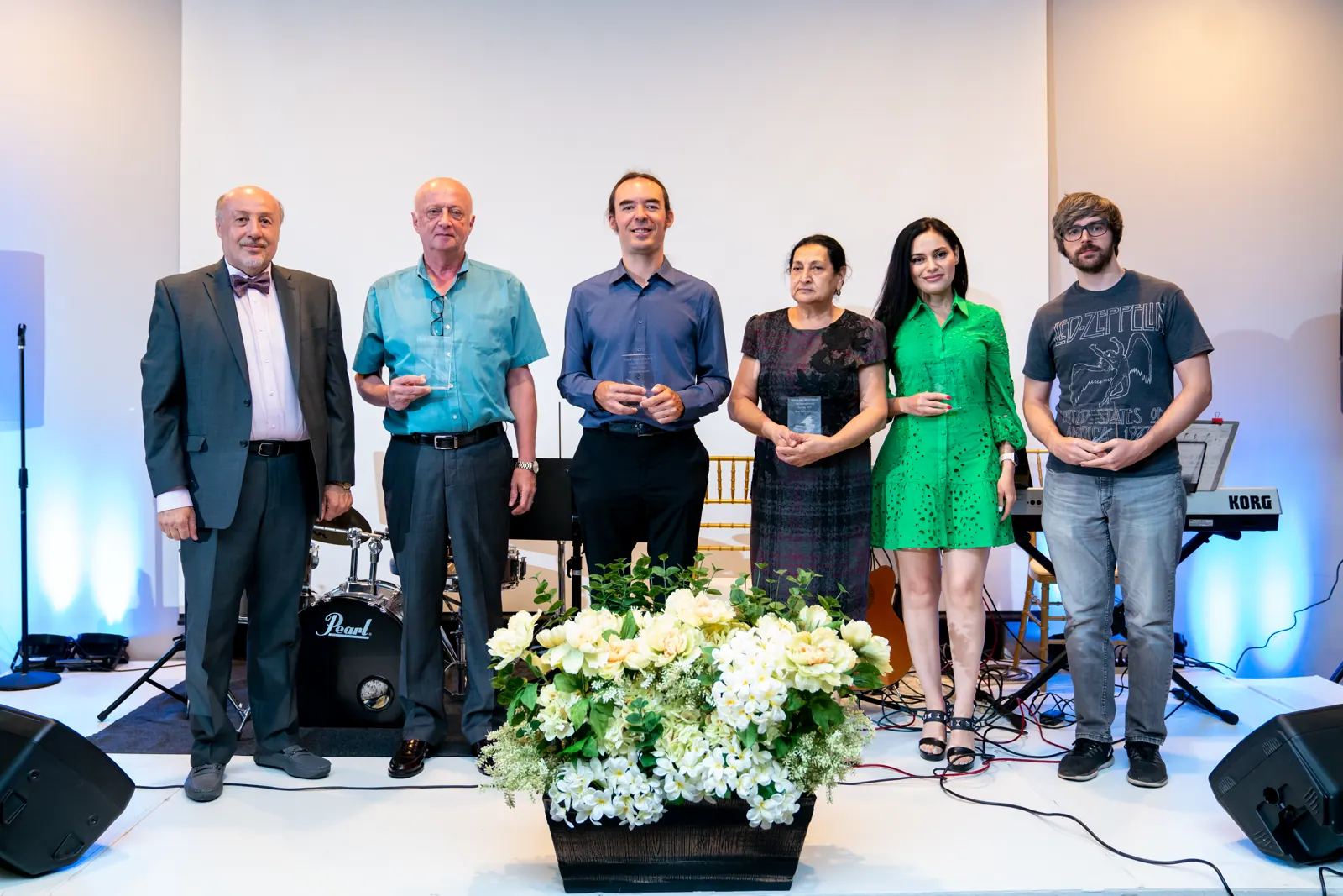 Melody International Music School instructors together on stage